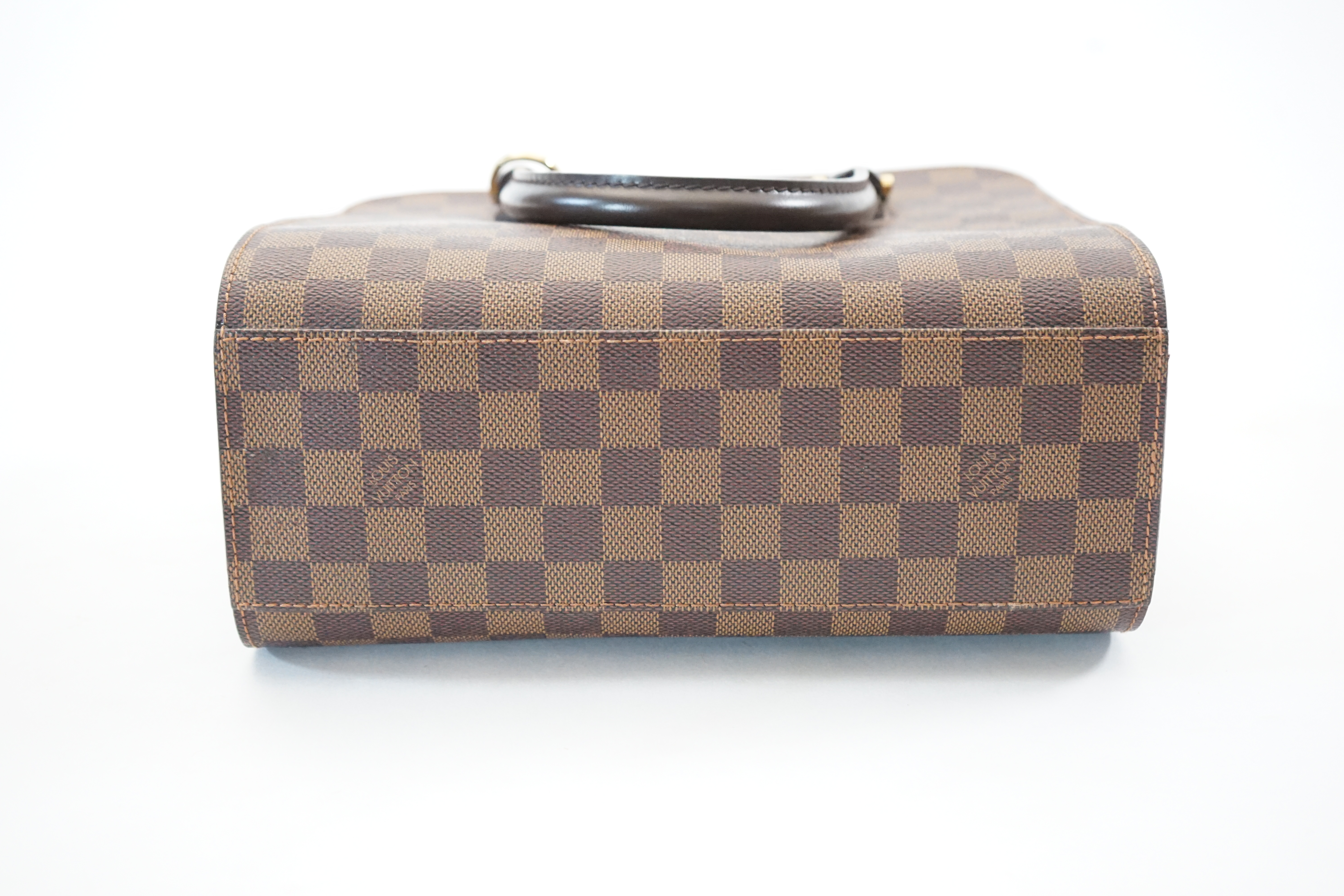 A Louis Vuitton Triana handbag, styled in Damier canvas width 26cm, depth 12cm, height 22cm handle 11cm